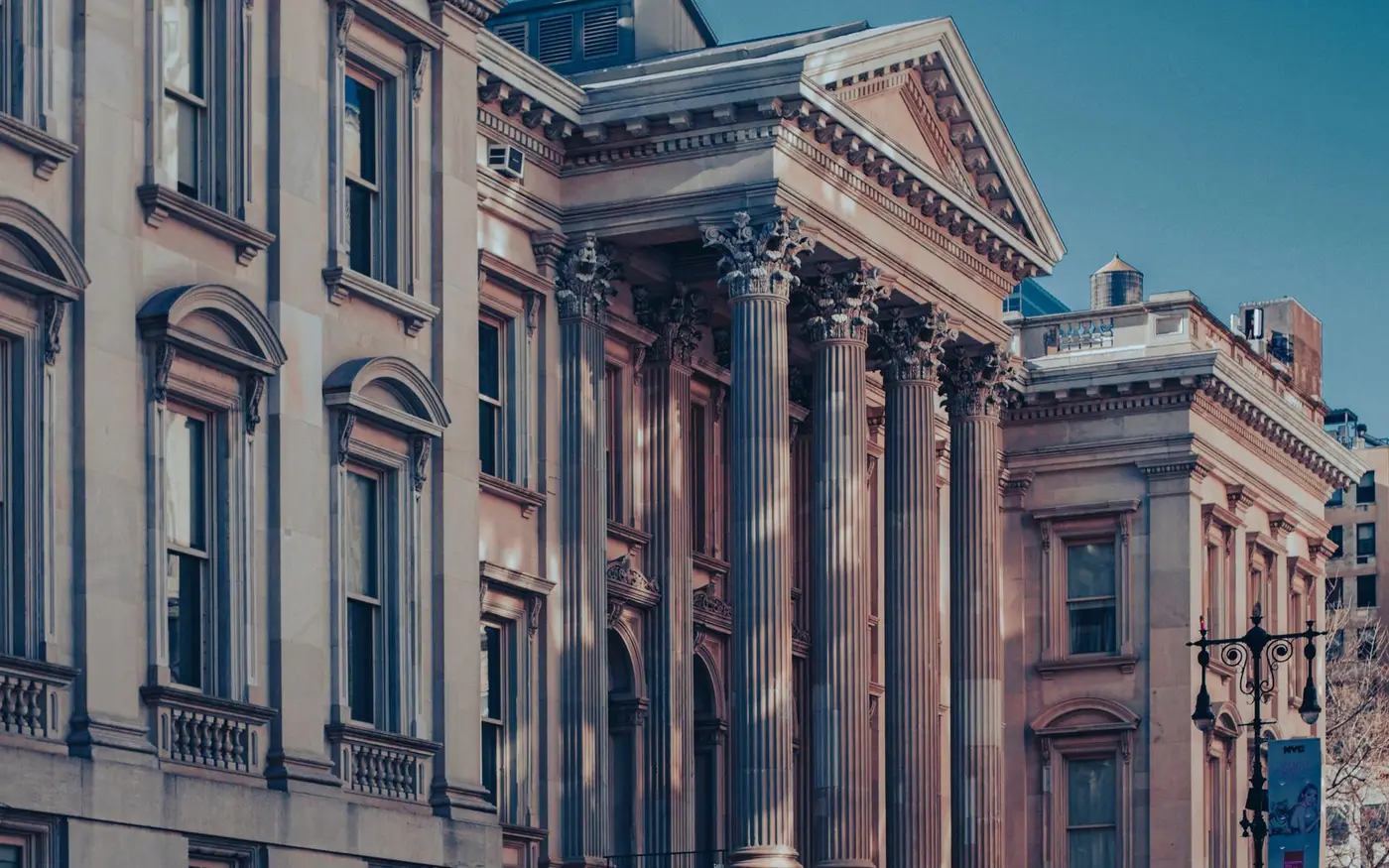 The columned facade of the Tweed Courthouse in Manhattan at dusk